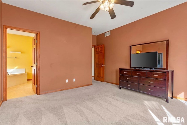 bedroom with visible vents, light carpet, ensuite bathroom, baseboards, and ceiling fan