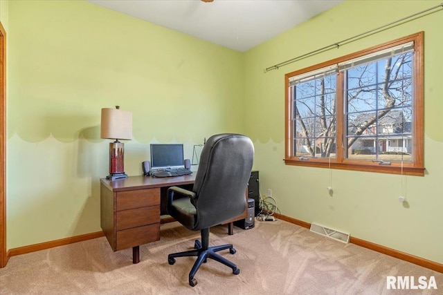 carpeted home office featuring visible vents and baseboards