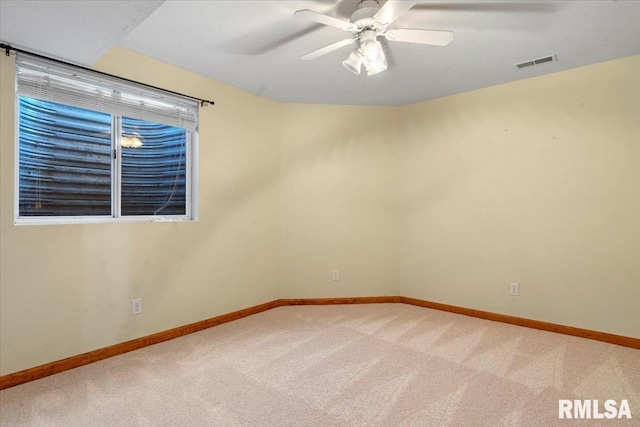 empty room with visible vents, baseboards, carpet, and a ceiling fan