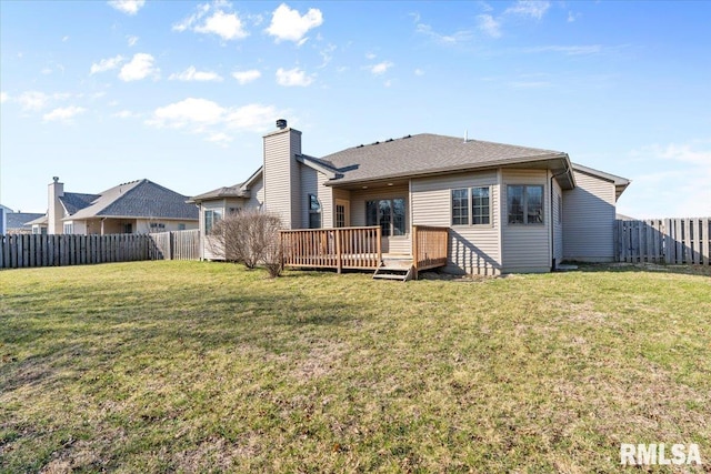 rear view of property featuring a chimney, a lawn, a wooden deck, and a fenced backyard