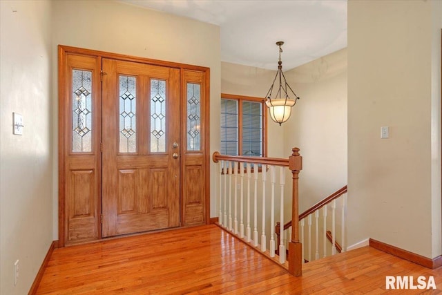 entrance foyer with light wood-style flooring and baseboards