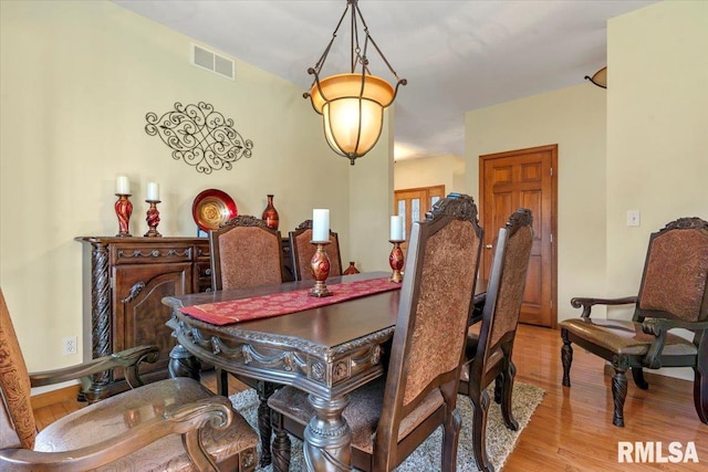 dining room with wood finished floors and visible vents