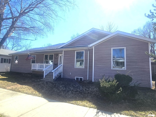 single story home with a porch