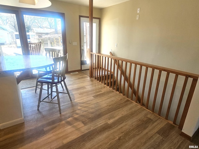 dining area with wood finished floors and baseboards