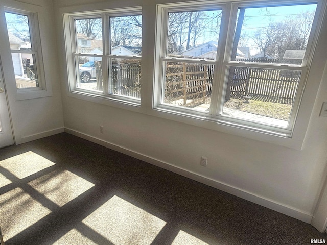 unfurnished room featuring baseboards