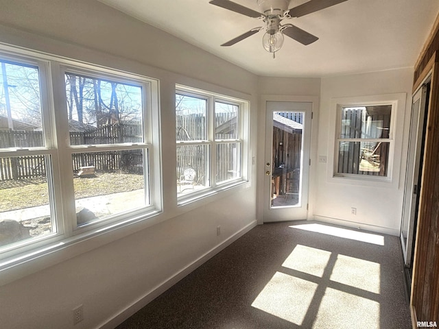 unfurnished sunroom with a ceiling fan