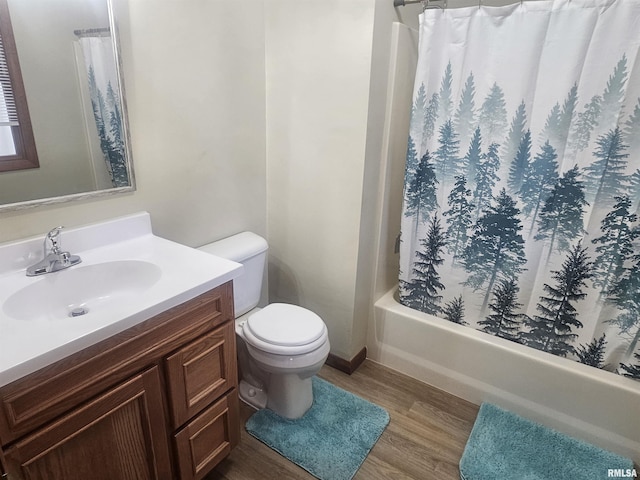 full bathroom with vanity, shower / bathtub combination with curtain, toilet, and wood finished floors