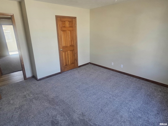 unfurnished bedroom featuring baseboards and carpet flooring