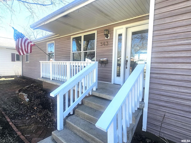 view of exterior entry featuring a porch