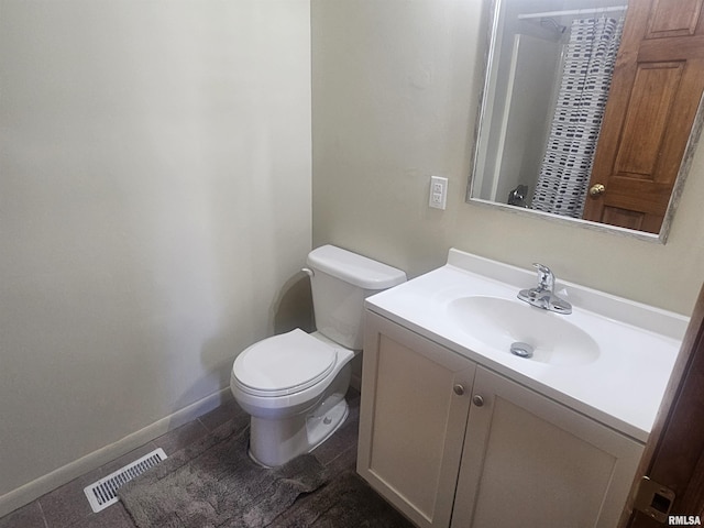 full bath with vanity, toilet, baseboards, and visible vents