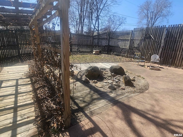 view of patio / terrace featuring a fenced backyard, a pergola, and an outdoor fire pit