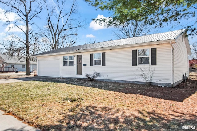 ranch-style home featuring aphalt driveway, a front lawn, metal roof, and a garage