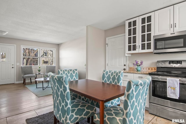 dining room with light wood-style floors and baseboards