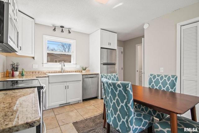 kitchen with light tile patterned floors, visible vents, appliances with stainless steel finishes, and white cabinets