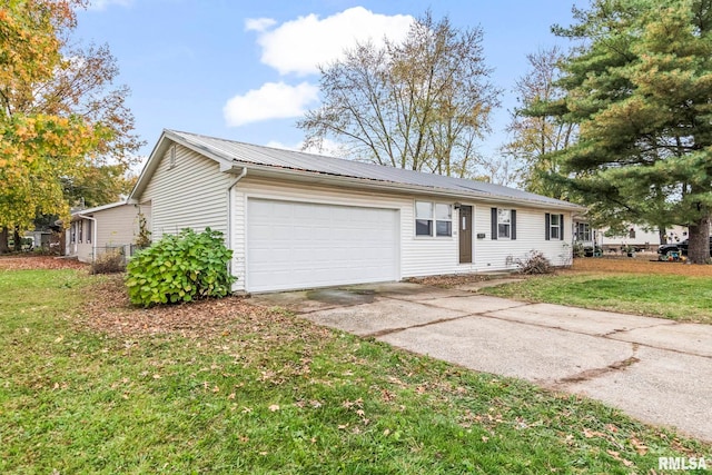 ranch-style home featuring a front lawn, metal roof, a garage, and concrete driveway