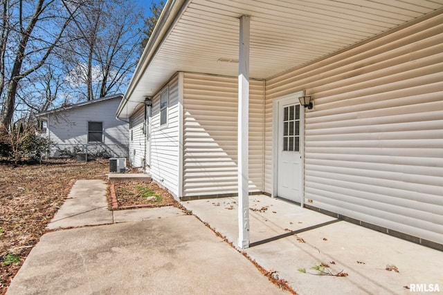 property entrance with a patio and central air condition unit