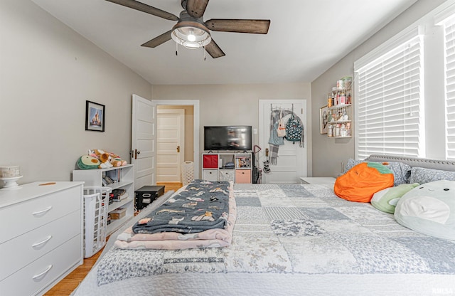 bedroom with light wood-style flooring and a ceiling fan