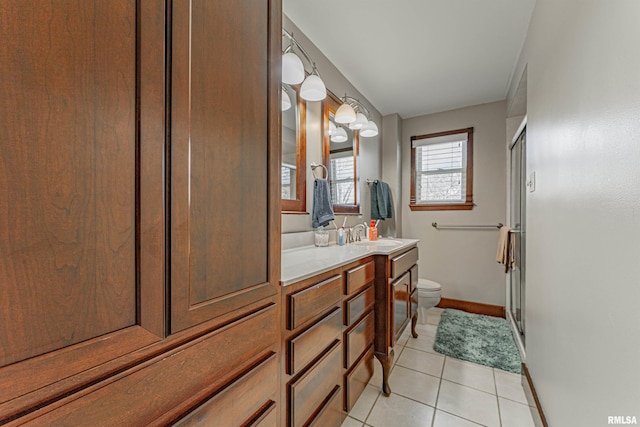 bathroom featuring vanity, baseboards, tile patterned flooring, a shower stall, and toilet