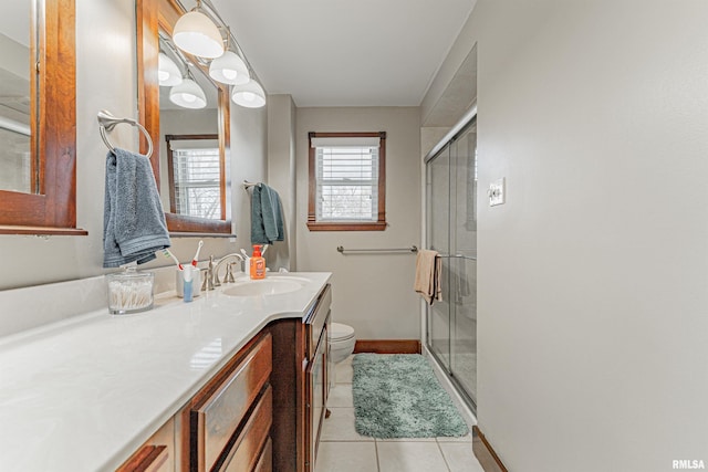 full bath with tile patterned flooring, baseboards, toilet, a stall shower, and vanity