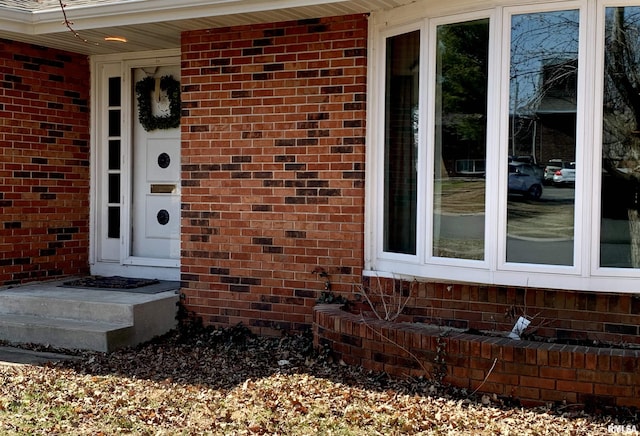 doorway to property with brick siding