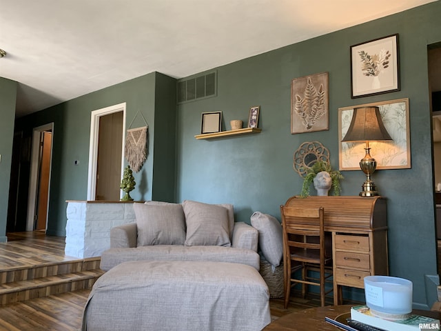 living room featuring visible vents and wood finished floors