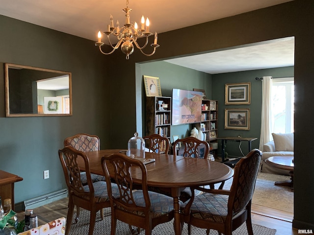 dining space featuring wood finished floors and a chandelier