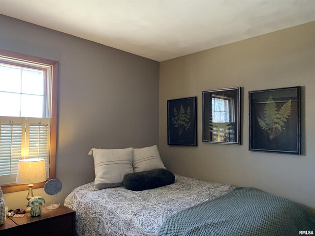 bedroom with a closet, baseboards, carpet, and a ceiling fan