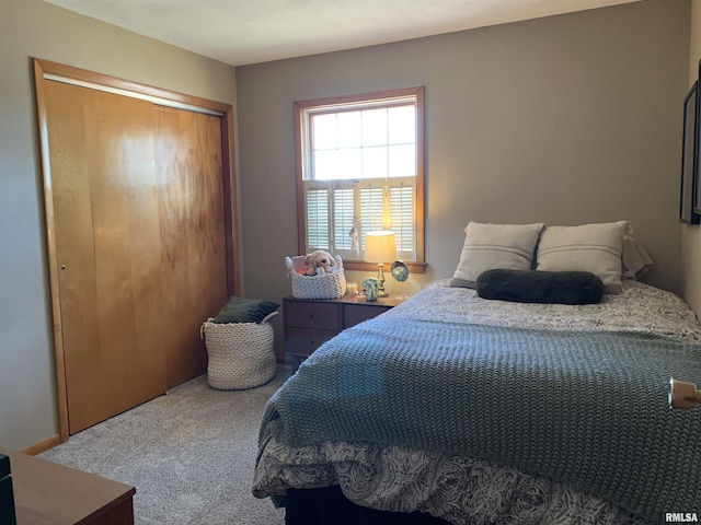 carpeted bedroom featuring a closet