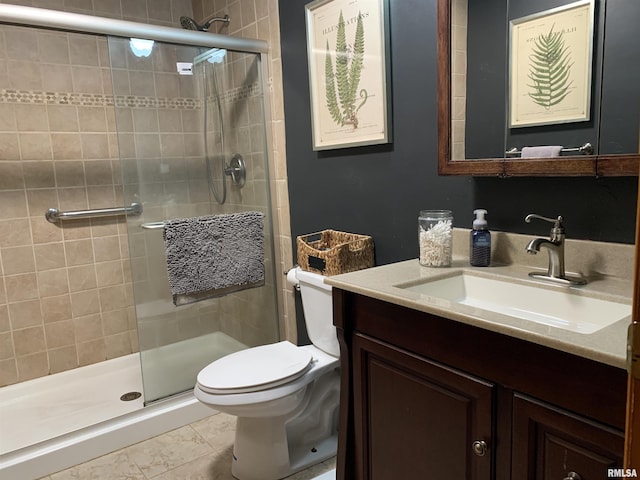 bathroom with toilet, a stall shower, and vanity