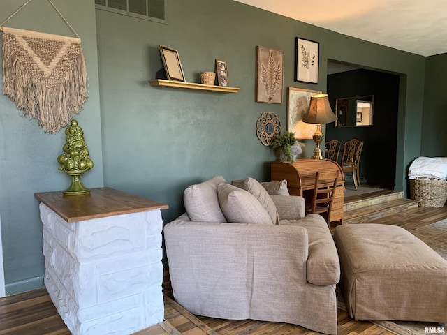 living room featuring visible vents and wood finished floors