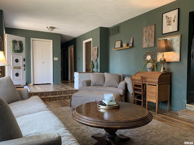 living area featuring wood finished floors and visible vents