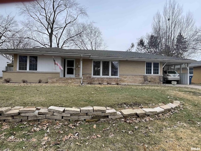 ranch-style home featuring brick siding, an attached carport, and a front lawn