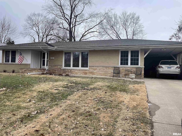 ranch-style house with stone siding, a carport, driveway, and a front yard