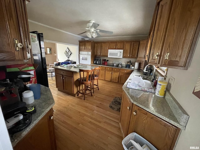 kitchen with white appliances, ceiling fan, a sink, crown molding, and light wood-type flooring