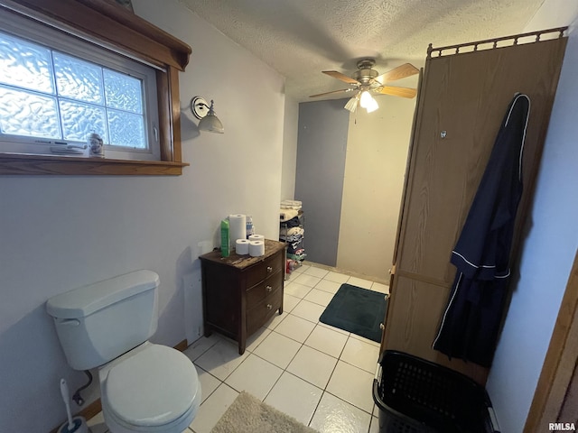 bathroom with tile patterned floors, a textured ceiling, toilet, and ceiling fan