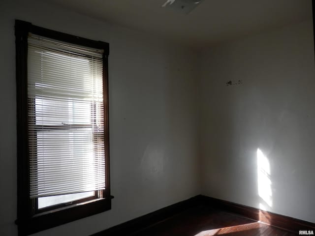 unfurnished room with baseboards