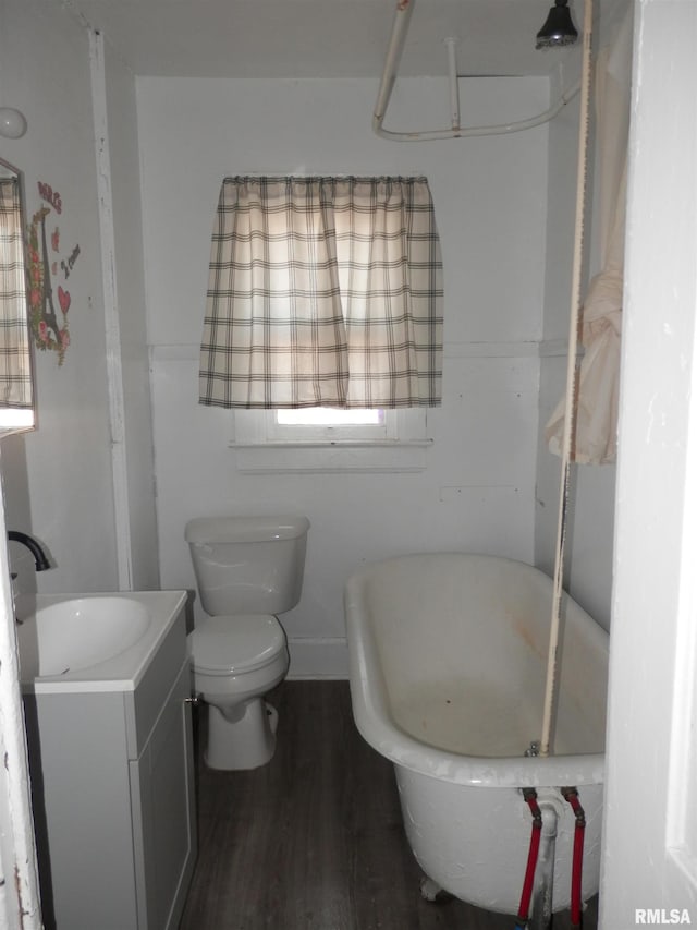 full bath featuring toilet, wood finished floors, and vanity