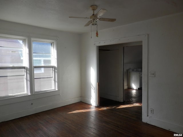 spare room featuring baseboards, a ceiling fan, and wood finished floors