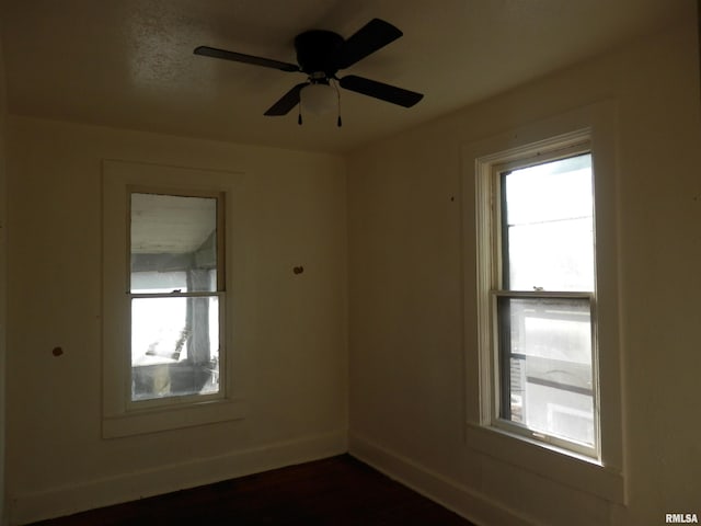 unfurnished room with baseboards and ceiling fan