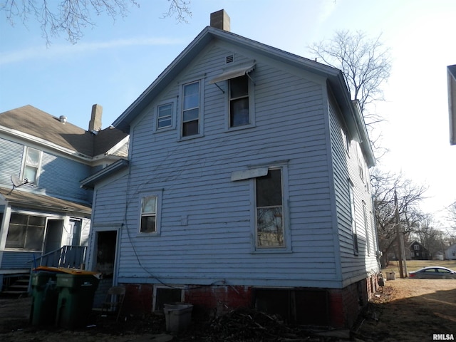 rear view of house with a chimney