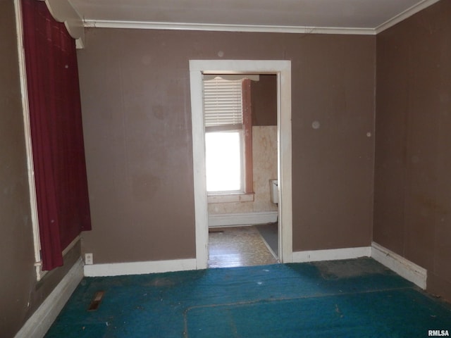 unfurnished room featuring baseboards and ornamental molding