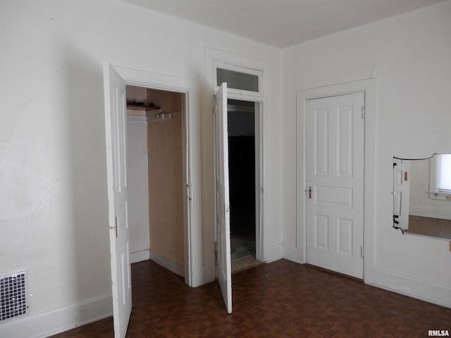 unfurnished bedroom featuring a closet, visible vents, and baseboards