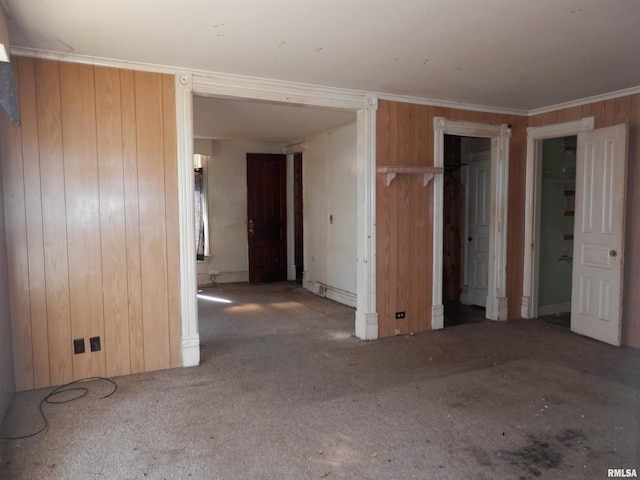 interior space featuring wood walls and ornamental molding