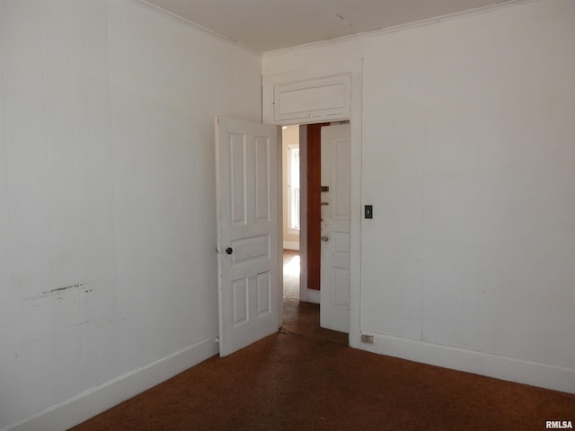 empty room with crown molding and carpet floors