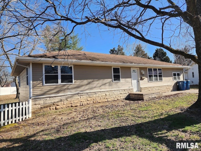 single story home featuring fence