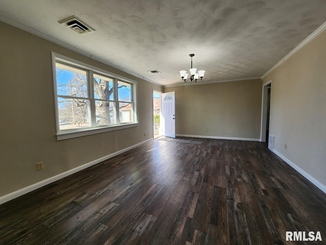 empty room featuring visible vents, a notable chandelier, ornamental molding, baseboards, and dark wood-style flooring