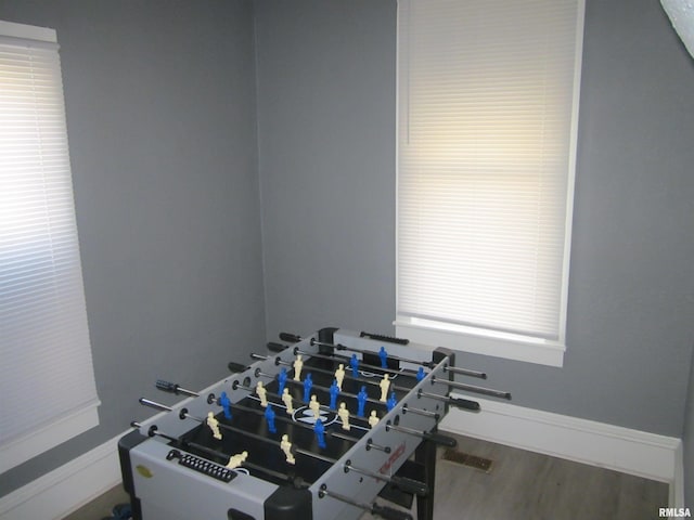 playroom with baseboards and wood finished floors