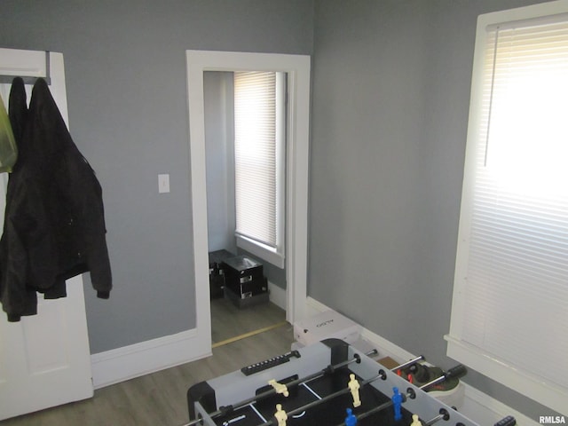 workout area featuring wood finished floors and baseboards