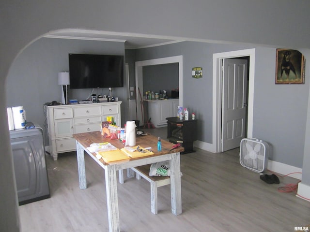 interior space with crown molding, baseboards, and light wood-type flooring