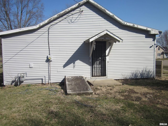 rear view of house with a yard